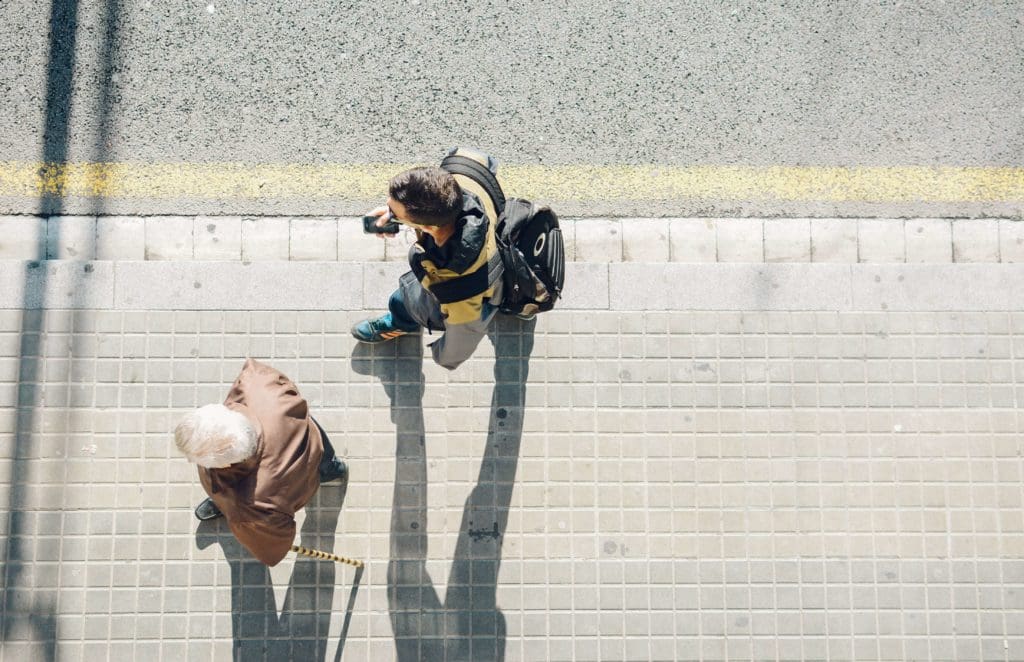 Two people walking on sidewalk