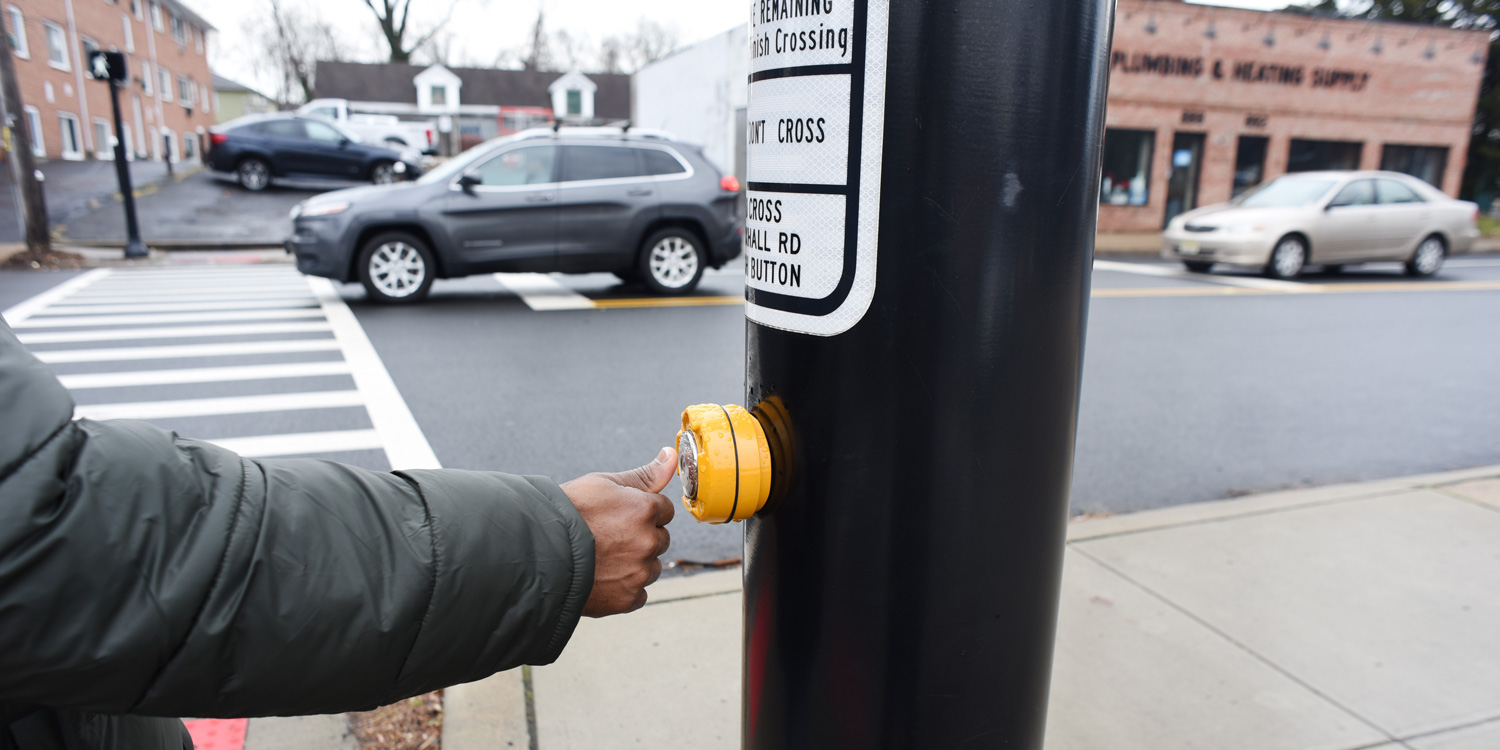 African American pressing the cross button. safety first. A blac