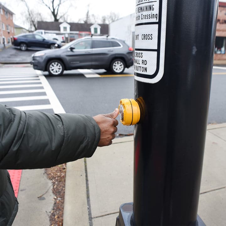 African American pressing the cross button. safety first. A blac