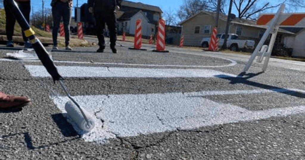 volunteers painting a crosswalk as part of a demonstration project