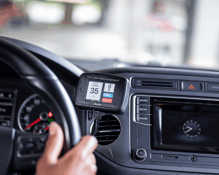 a person driving a car with intelligent speed assistance installed