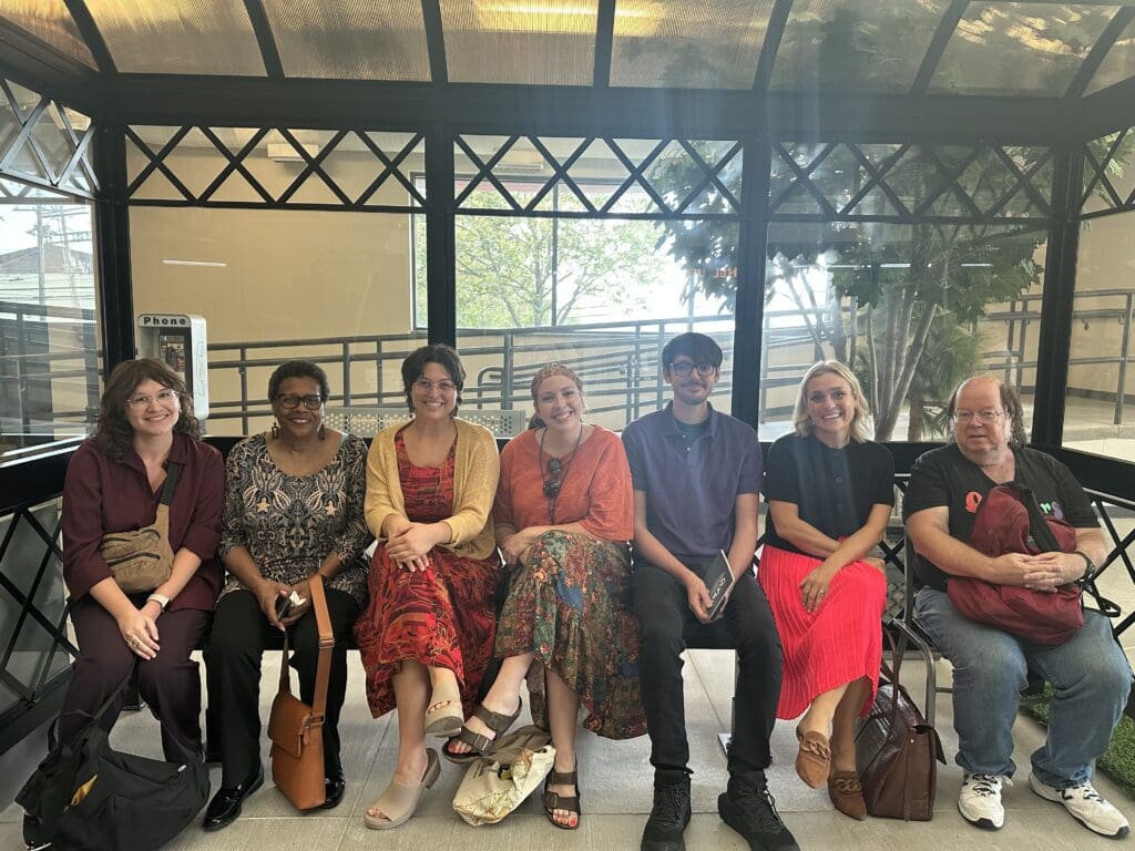 people sit at a bus stop at the ohio state mobility assessment center