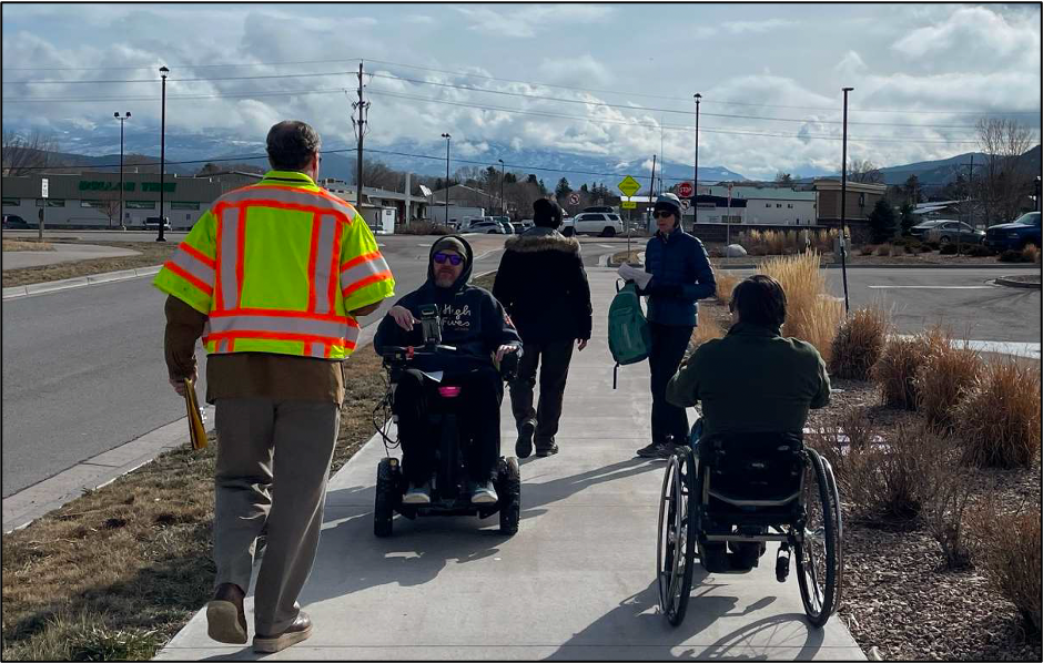 a traffic engineer conducts a walk audit of highway 133 with the age-friendly carbondale team and disability advocates
