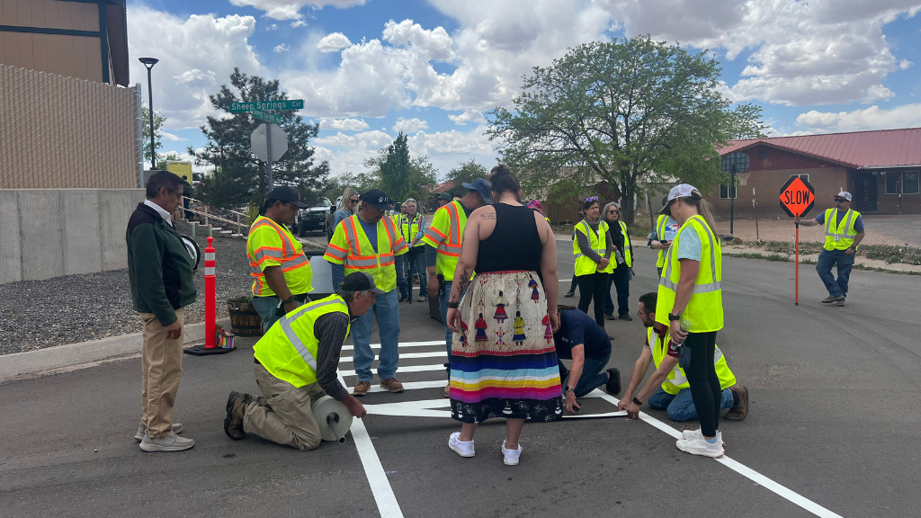 volunteers lay down a crosswalk