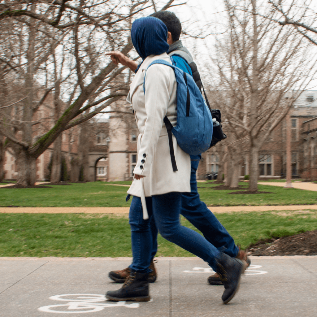people walking on a sidewalk