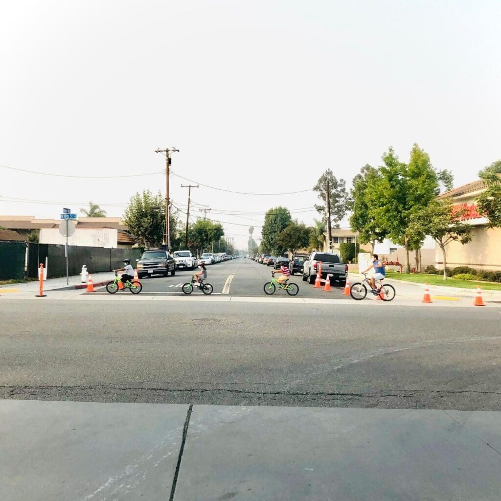people biking across a street