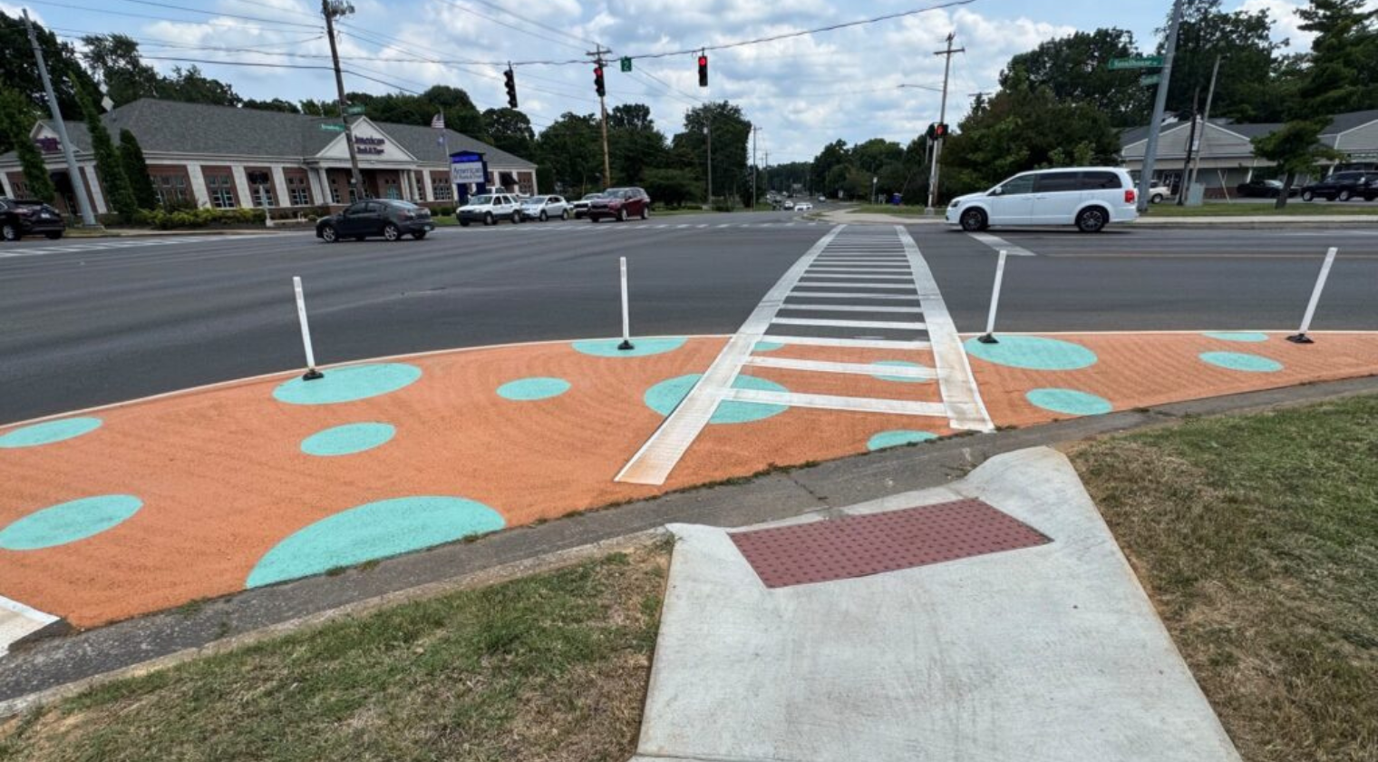a quick-build and painted bulb-out at a crosswalk