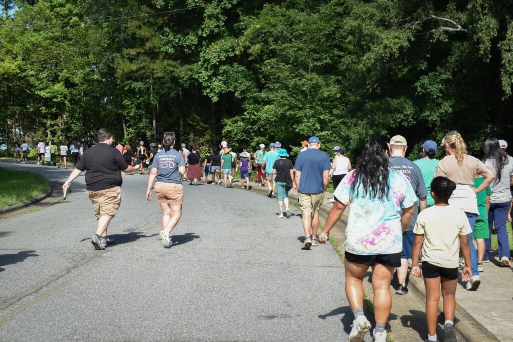 people walking on a road and sidewalk